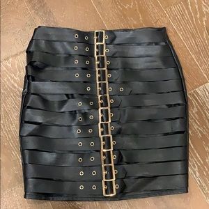 Black leather skirt with gold buckles